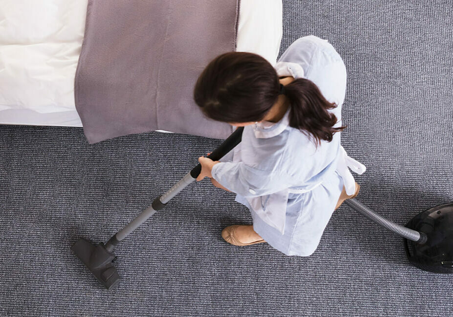 Lady cleaning carpet floor | Pierce Flooring Wholesale Direct